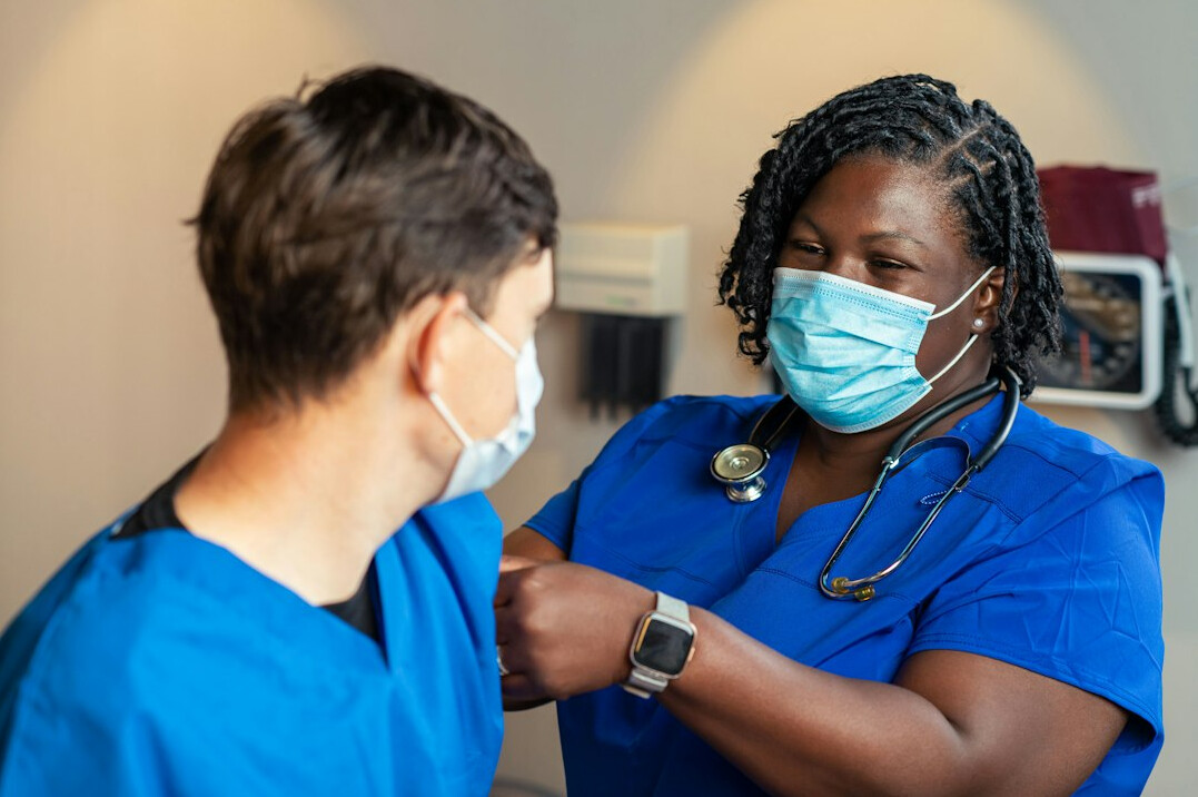 nurse assisting patient