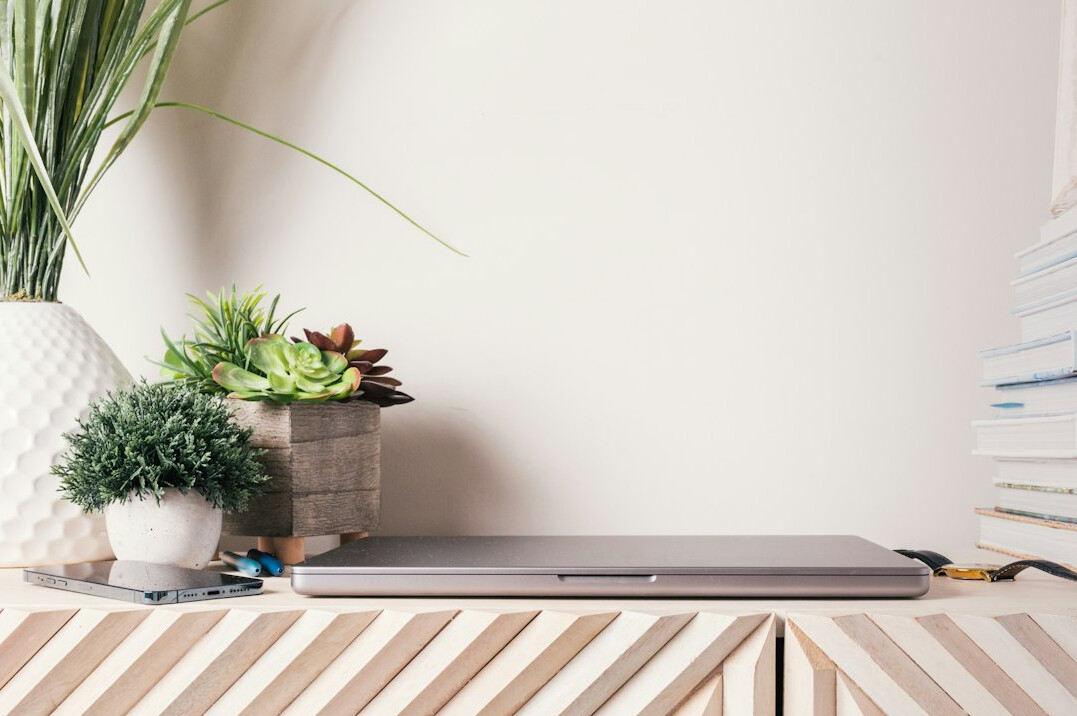 Laptop with online medical course, stethoscope and notebook on a bright desk