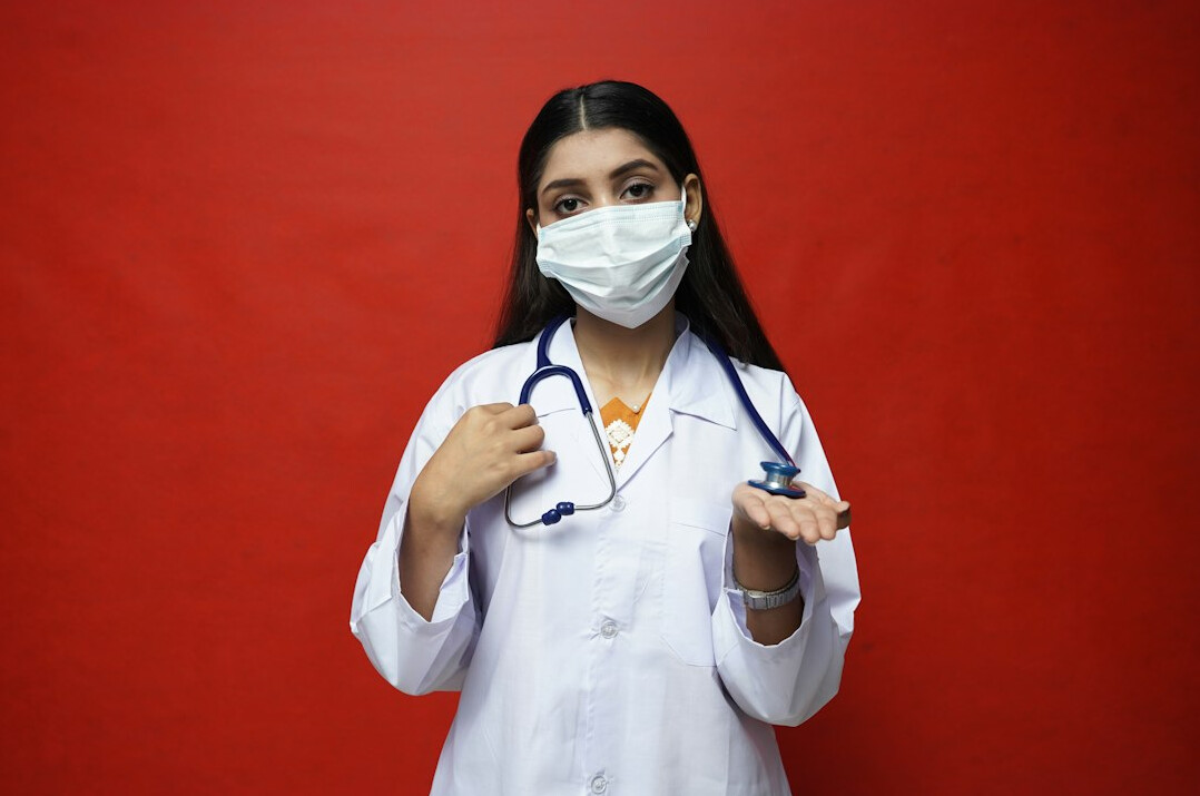 Portrait of a smiling woman doctor in a white coat